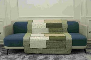 Patterned shade of green quilted sofa sujni